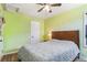 Cozy bedroom with green walls, wood flooring, ceiling fan, and bright windows at 2896 Depew St, Wheat Ridge, CO 80214