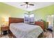 Cozy bedroom with green walls, wood flooring, ceiling fan, and bright windows at 2896 Depew St, Wheat Ridge, CO 80214