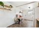 Eat-in kitchen features tile floors, white walls, shelves, and a bright window at 2896 Depew St, Wheat Ridge, CO 80214
