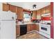 Well-lit kitchen with wood cabinetry, modern appliances, and efficient layout at 2896 Depew St, Wheat Ridge, CO 80214