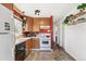 Functional kitchen with warm wood cabinets, modern appliances, and a bright window at 2896 Depew St, Wheat Ridge, CO 80214