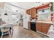 Combined kitchen and dining space featuring modern appliances and a functional layout at 2896 Depew St, Wheat Ridge, CO 80214