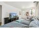 Cozy living room with a comfortable gray sectional, TV, and charming decor at 2896 Depew St, Wheat Ridge, CO 80214