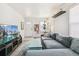 Bright living room showcasing a gray sectional, modern TV stand, and stylish decor at 2896 Depew St, Wheat Ridge, CO 80214