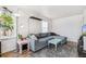 Stylish living room featuring a sectional, vintage coffee table and plenty of natural light at 2896 Depew St, Wheat Ridge, CO 80214