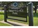 A black sign reads 'Sloan's Lake Park' with the Denver Parks & Recreation logo above at 2896 Depew St, Wheat Ridge, CO 80214