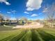 A vibrant playground with climbing structures, swings, and soft groundcover; set against blue skies at 2896 Depew St, Wheat Ridge, CO 80214