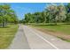 A wide paved path lined with trees and lush greenery perfect for walking and biking at 2896 Depew St, Wheat Ridge, CO 80214