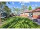 Expansive backyard with lush green lawn, mature trees, and cozy seating area, perfect for outdoor entertaining at 9301 Ciancio St, Thornton, CO 80229