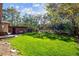 Well-maintained backyard with ample space, a swing, and a storage shed, offering both functionality and enjoyment at 9301 Ciancio St, Thornton, CO 80229