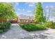 Inviting home with a brick exterior, manicured lawn, mature trees and a paved driveway at 9301 Ciancio St, Thornton, CO 80229