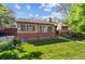 Charming brick home featuring a well-maintained lawn, beautiful garden, and an American flag at 9301 Ciancio St, Thornton, CO 80229