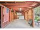 Rustic garage with exposed beams, storage cabinets, and an American flag at 9301 Ciancio St, Thornton, CO 80229