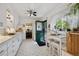 Well-lit kitchen with adjacent breakfast nook and green back door at 9301 Ciancio St, Thornton, CO 80229