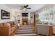 Warm living room with hardwood floors, fireplace, leather sofa, and natural light from windows at 9301 Ciancio St, Thornton, CO 80229