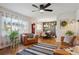 Inviting living room showcasing hardwood floors, leather furniture, large windows, and stylish decor at 9301 Ciancio St, Thornton, CO 80229