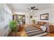 Open concept living and dining area featuring hardwood floors, leather sofas, and natural light at 9301 Ciancio St, Thornton, CO 80229