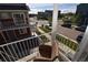 Relaxing balcony view showcasing the neighborhood, offering a peaceful outdoor living space with a comfortable chair at 17747 E 54Th Ave, Denver, CO 80249