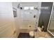 Updated bathroom features shower over tub, stylish gray tile and modern fixtures at 17747 E 54Th Ave, Denver, CO 80249