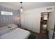 Comfortable bedroom with decorative accent wall and closet with doors at 17747 E 54Th Ave, Denver, CO 80249