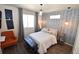 Cozy bedroom with an accent wall, hardwood floors and ample natural light at 17747 E 54Th Ave, Denver, CO 80249