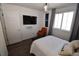 Bedroom features large window, an orange accent chair and plush flooring at 17747 E 54Th Ave, Denver, CO 80249