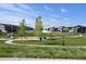 Scenic view of a well-equipped community park with playground, picnic gazebo, and manicured lawns at 17747 E 54Th Ave, Denver, CO 80249
