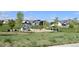 Community park featuring a playground, picnic shelter, and open green space at 17747 E 54Th Ave, Denver, CO 80249