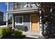 Inviting front entrance with a dutch door, bench, and landscaped yard, creating a warm and welcoming first impression at 17747 E 54Th Ave, Denver, CO 80249