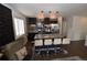 Stylish kitchen with dark cabinetry, stainless steel appliances, granite countertops, and island with seating at 17747 E 54Th Ave, Denver, CO 80249