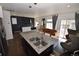 Open-concept kitchen with granite countertops, stainless steel appliances, and seamless transition to the living area at 17747 E 54Th Ave, Denver, CO 80249