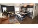 Stylish kitchen featuring dark cabinetry, a granite island with seating, and stainless steel appliances, perfect for modern living at 17747 E 54Th Ave, Denver, CO 80249