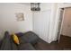 Comfortable living room featuring a gray sectional, closet, and decorative lighting fixture at 17747 E 54Th Ave, Denver, CO 80249