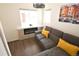 Living room with a fireplace, hardwood floors, and a modern sectional sofa at 17747 E 54Th Ave, Denver, CO 80249