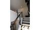 Staircase with contrasting black and white design elements and sleek railing at 17747 E 54Th Ave, Denver, CO 80249