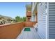 Comfortable balcony with white chairs and wood railings overlooking the community at 4135 E 119Th Pl # A, Thornton, CO 80233