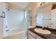 Bathroom features a shower-tub combo, vanity, and tile flooring at 4135 E 119Th Pl # A, Thornton, CO 80233