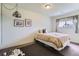 Bright bedroom featuring neutral walls and carpet with a window providing natural light at 4135 E 119Th Pl # A, Thornton, CO 80233