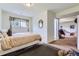 View of a bedroom featuring carpeted floors, a queen size bed, and an ensuite office space at 4135 E 119Th Pl # A, Thornton, CO 80233