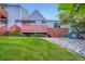 Inviting townhouse featuring a front porch, brick accents, and a well-maintained lawn at 4135 E 119Th Pl # A, Thornton, CO 80233