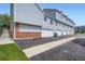 Exterior view of garages and townhomes in a community, with paved driveway and sidewalk at 4135 E 119Th Pl # A, Thornton, CO 80233