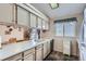Cozy kitchen features light countertops, wood look flooring, dining area, and lots of cabinet space at 4135 E 119Th Pl # A, Thornton, CO 80233