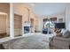 Bright living room with a fireplace and built-in shelves, creating a cozy atmosphere at 4135 E 119Th Pl # A, Thornton, CO 80233