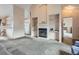 Open living area with a fireplace, built-in shelves, and seamless flow to kitchen at 4135 E 119Th Pl # A, Thornton, CO 80233