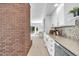 Basement bar with white cabinets, a decorative backsplash, and wine storage at 22196 Boar Head Rd, Indian Hills, CO 80454