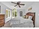 Bright bedroom with a king-size bed and ceiling fan at 22196 Boar Head Rd, Indian Hills, CO 80454