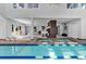 Indoor lap pool and hot tub with access to backyard at 22196 Boar Head Rd, Indian Hills, CO 80454