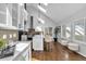 Bright kitchen features white cabinets, stainless steel appliances, and a large island at 22196 Boar Head Rd, Indian Hills, CO 80454