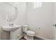 Modern bathroom with a pedestal sink, toilet, and window at 458 Millwall Cir, Castle Pines, CO 80108