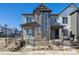 Modern two-story home featuring varied siding and a partially fenced front yard and newly installed landscape at 458 Millwall Cir, Castle Pines, CO 80108